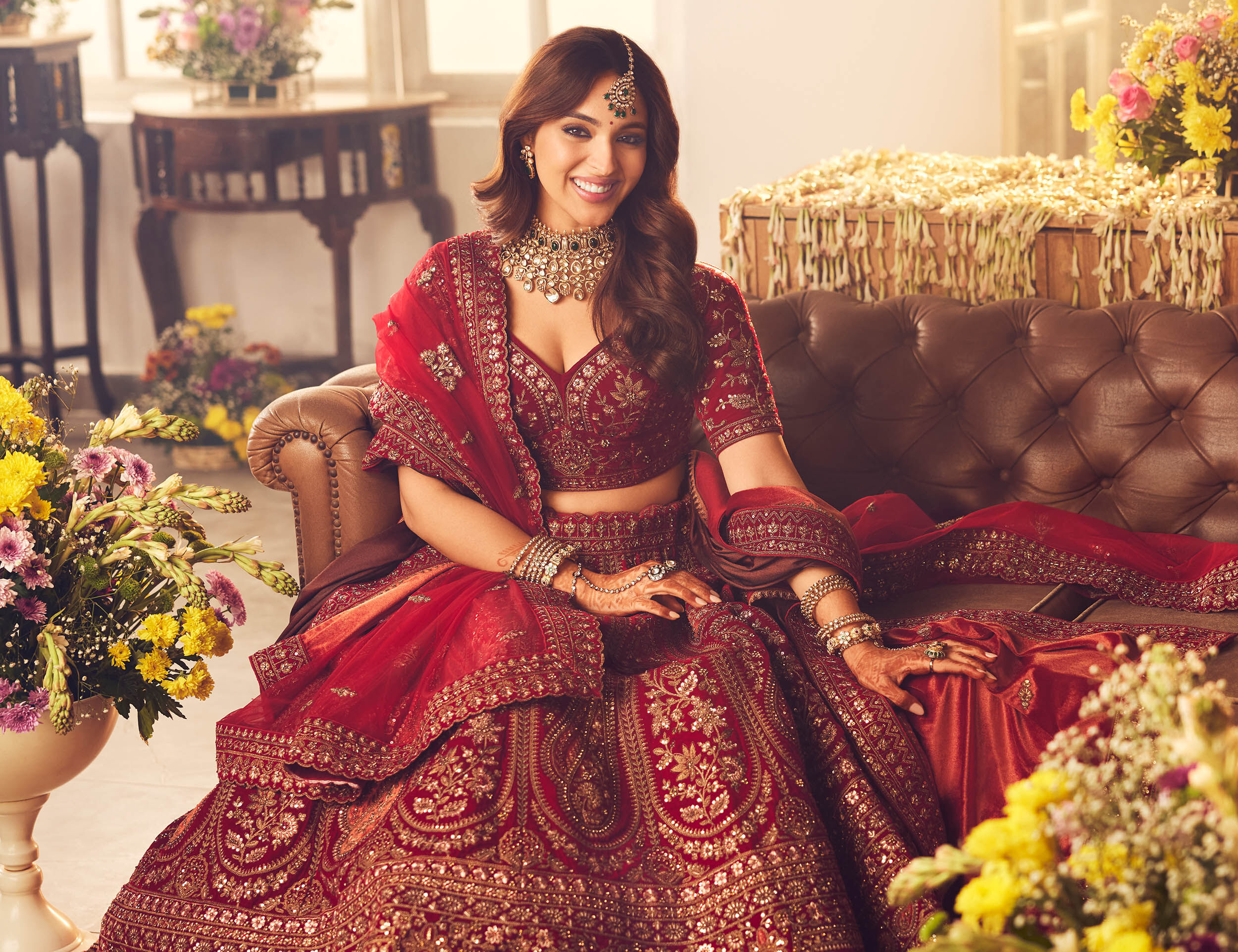 Bride wearing red lehenga with red choli blouse for wedding ceremony